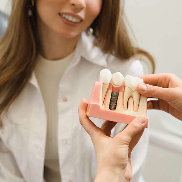 dr showing dental implant example